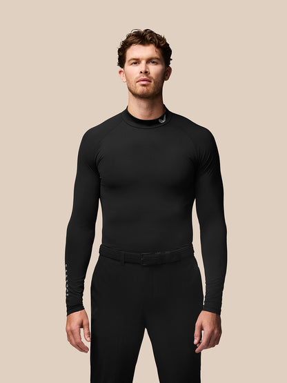 Male golfer wearing a black long sleeve golf baselayer with stand collar