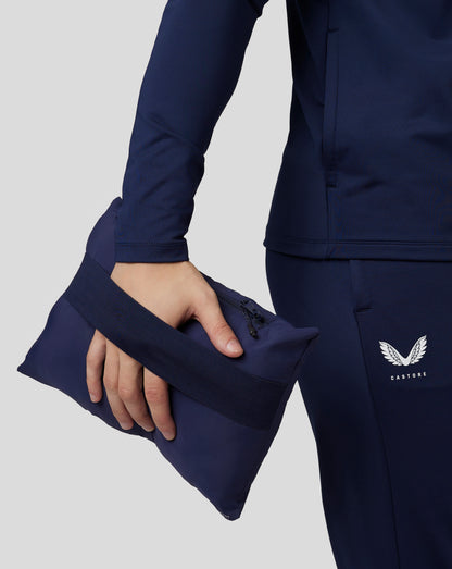 Navy Castore travel lightweight puffer jacket sleeve with a zipped side pocket and Castore logo.