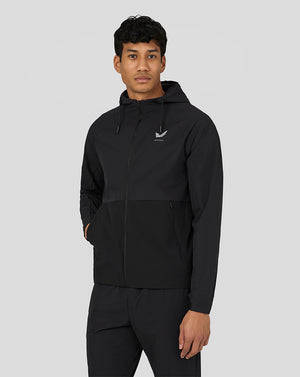 Male model wearing black men's active lightweight woven jacket with hood front zipper and side pockets
