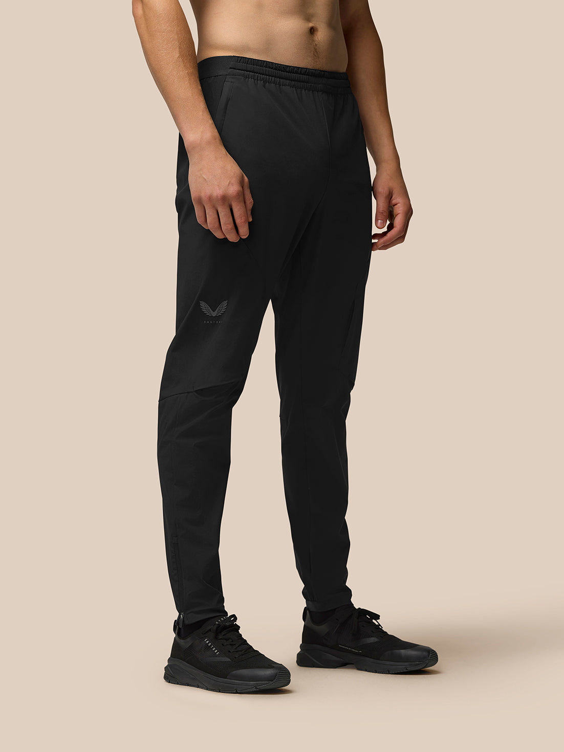 Man wearing black Flex Training Joggers with Castore logo on left thigh.