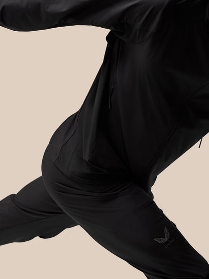 Action shot of black Flex Training Joggers with zip pockets and logo on thigh.