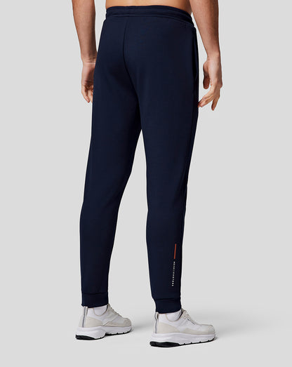 Back view of midnight navy men's recovery joggers with a tapered leg and cuffed hems, Castore branding on the lower right leg.
