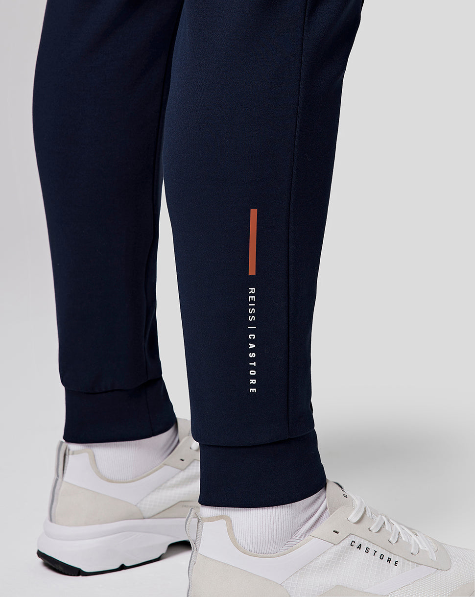 Navy recovery jogger leg with an orange vertical stripe and Castore branding