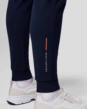Navy recovery jogger leg with an orange vertical stripe and Castore branding