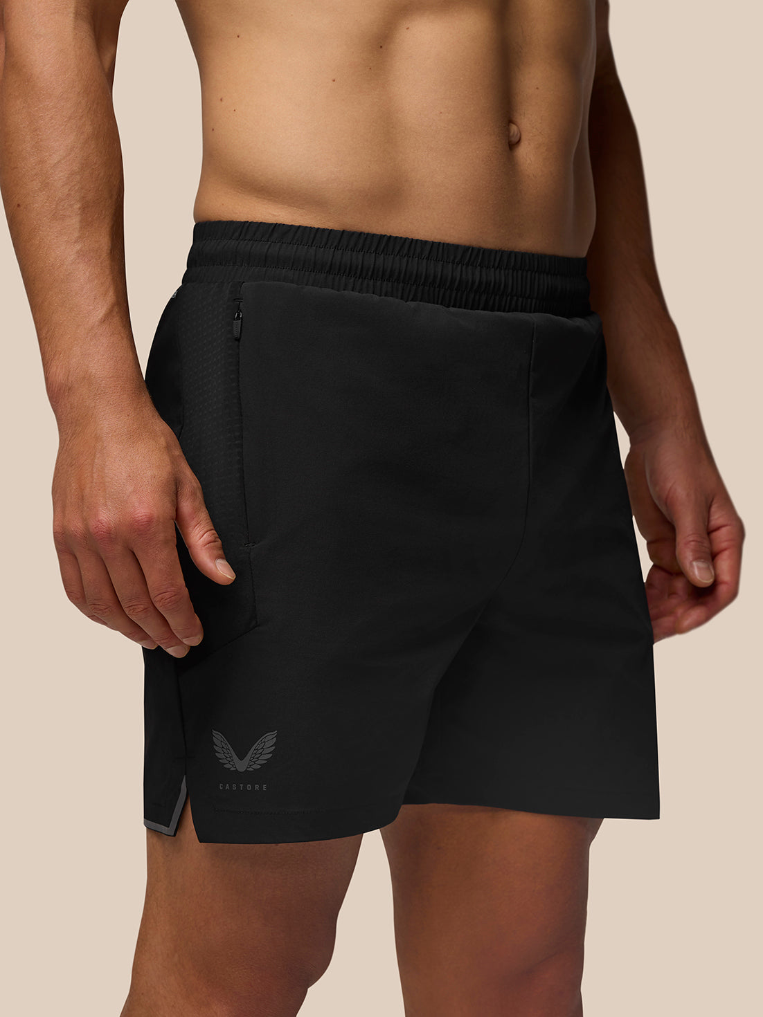 Male model wearing black Apex Training Shorts with zip side pocket and internal drawcords