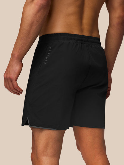 Back view of black Apex Training Shorts with zipped side pocket and reflective branding along the thigh