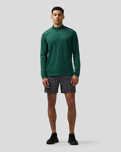 Front view of a model wearing Apex Training Shorts gunmetal with a green top