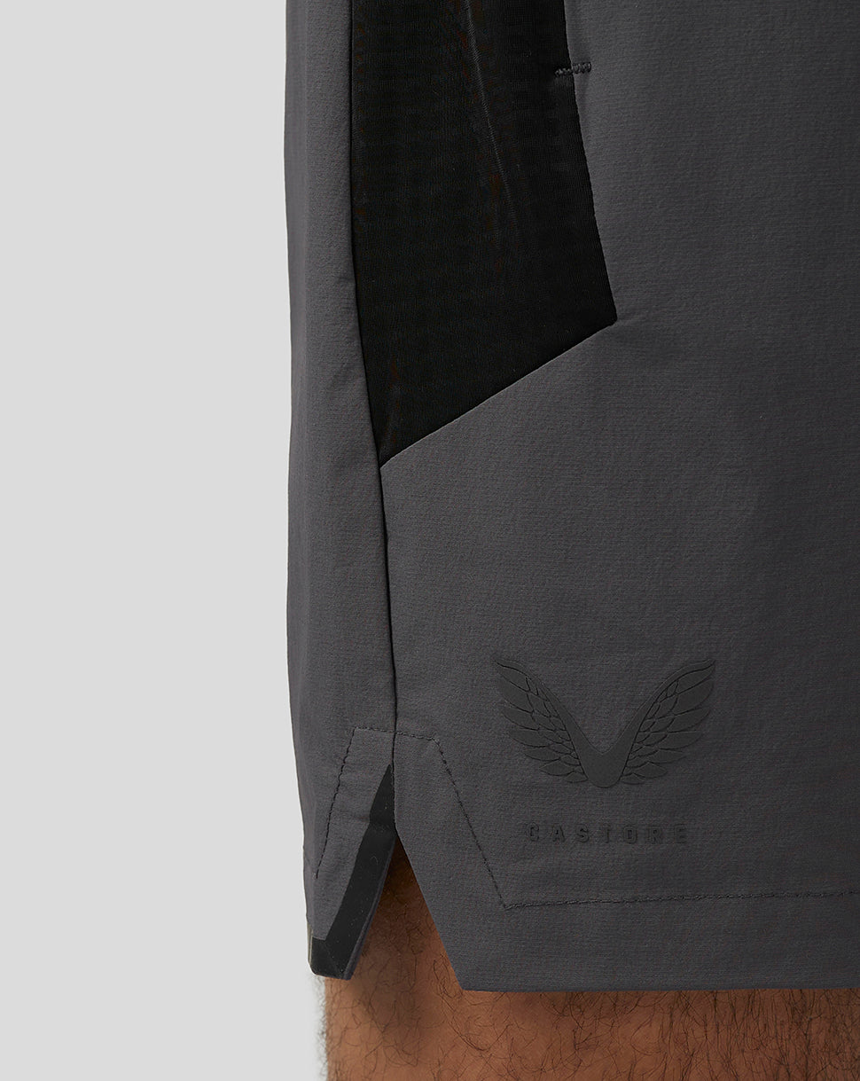 Close-up of the gunmetal Apex Training Shorts hem showing the Castore wing logo