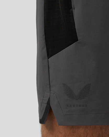 Close-up of the gunmetal Apex Training Shorts hem showing the Castore wing logo