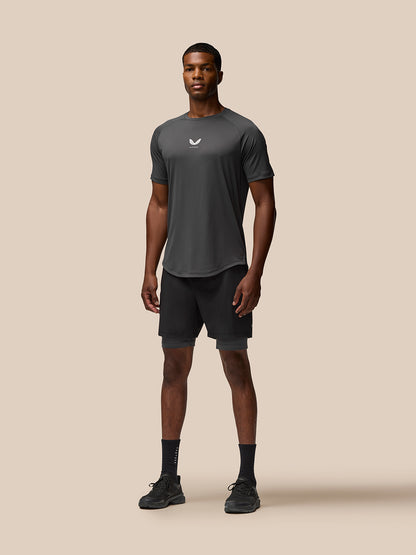 Male model wearing Flow Training Shorts in black with elastic waistband and side pockets; Castore branding on the thigh