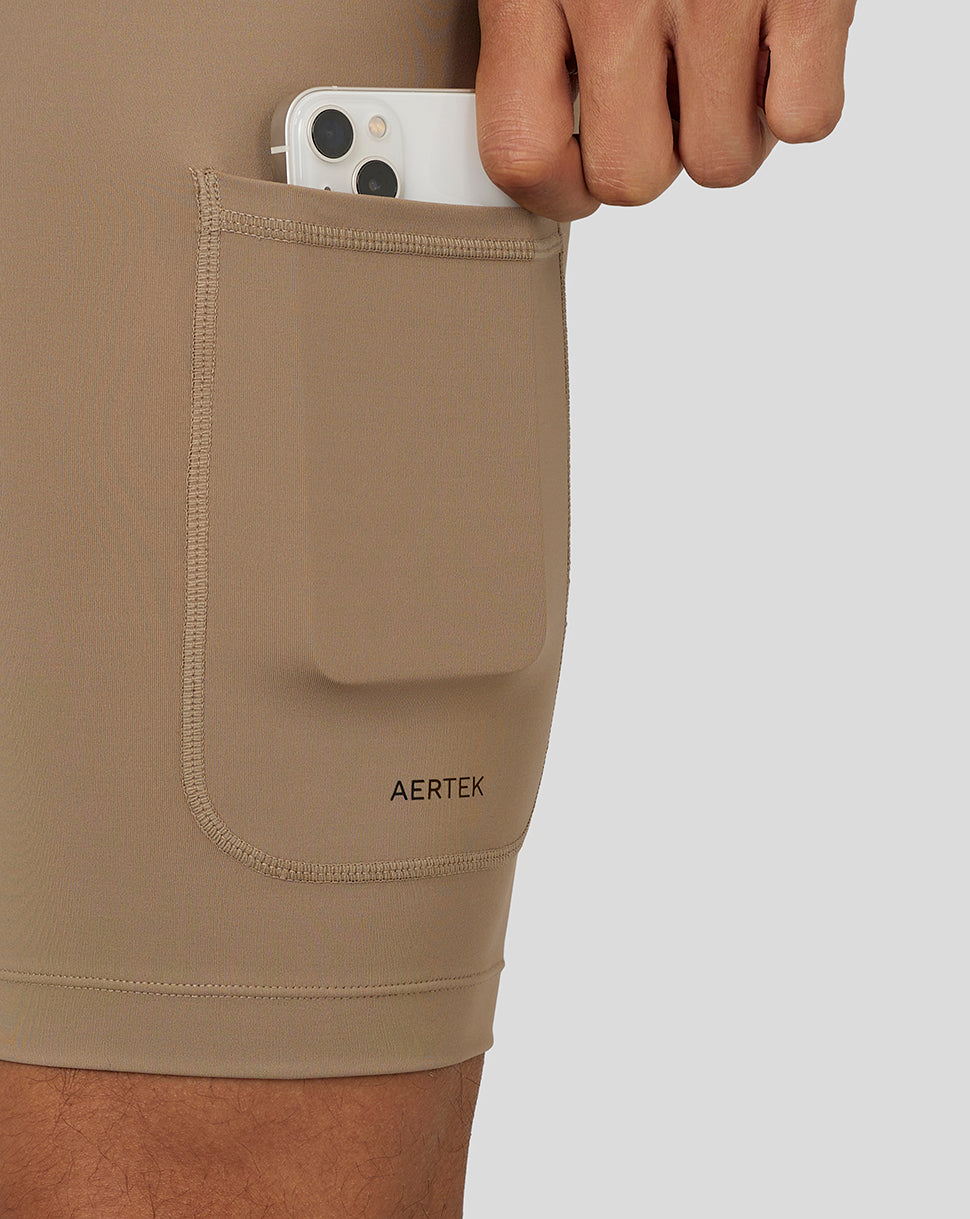Side pocket detail on Flow Training Shorts with a phone tucked in