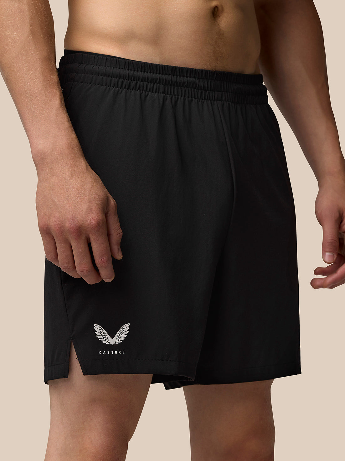 Close-up of black Adapt Training shorts waistband with logo on the thigh