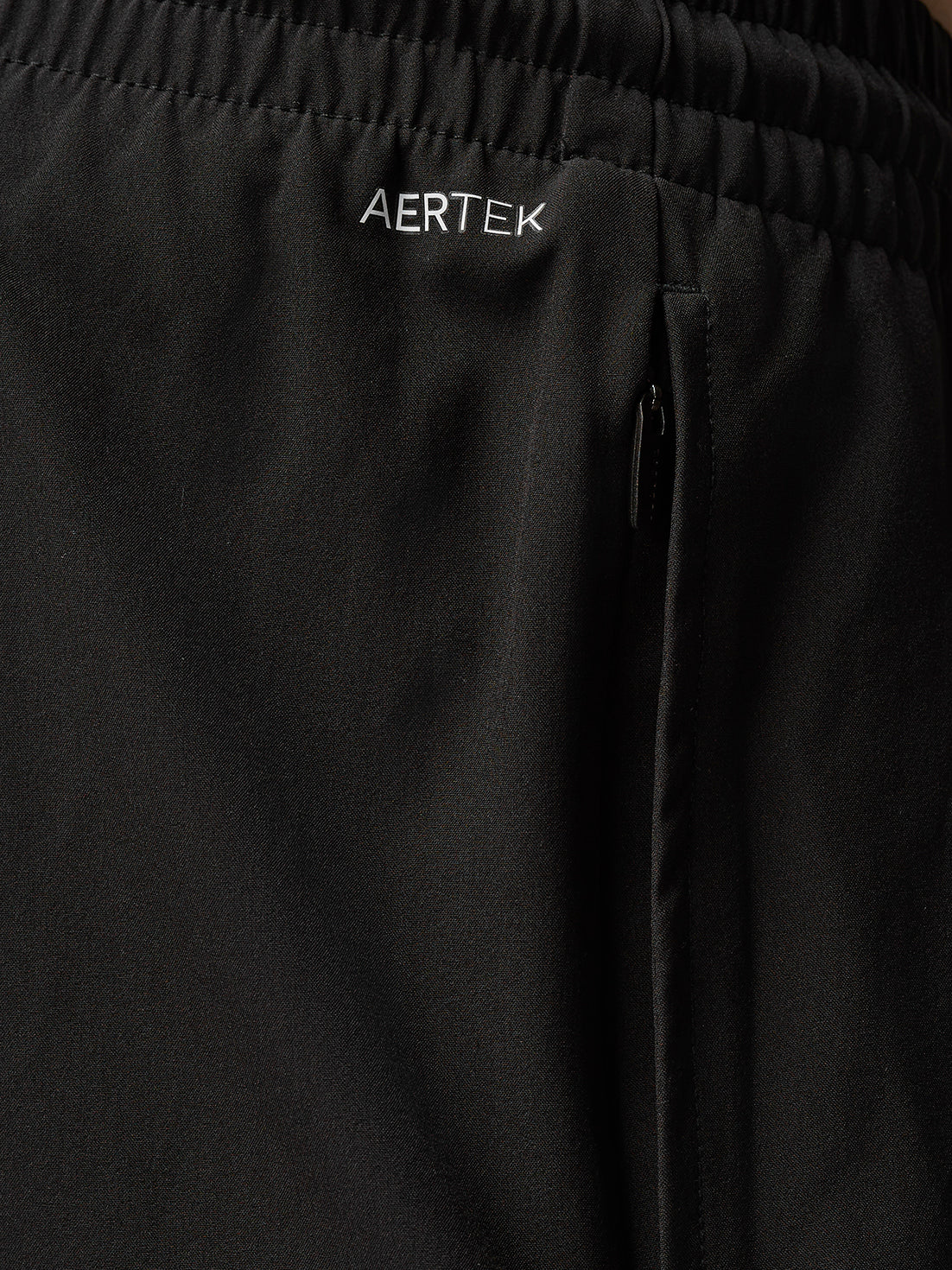 Close-up of black Adapt Training shorts waistband displaying AERTEK branding