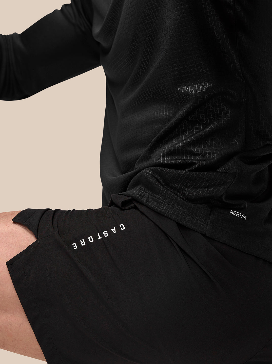 Back view of black Adapt Training shorts with Aertek logo at right rear and Castore branding along left leg