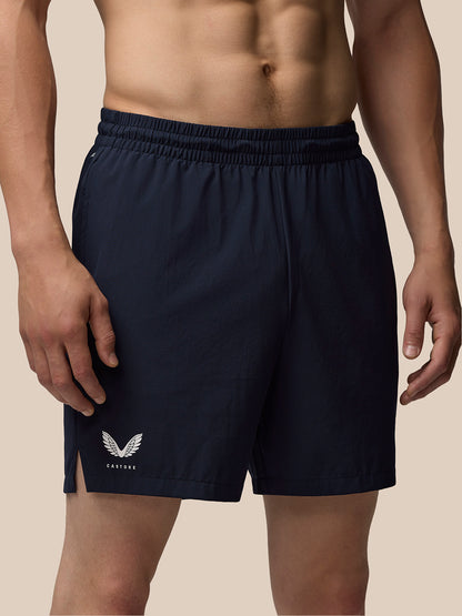 Navy Adapt 7 inch shorts with elastic waistband and side pocket; Castore branding on the thigh.