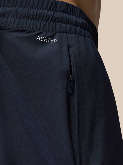 Navy Adapt Training shorts close-up showing Aertek branding on the waistband and side zip pocket