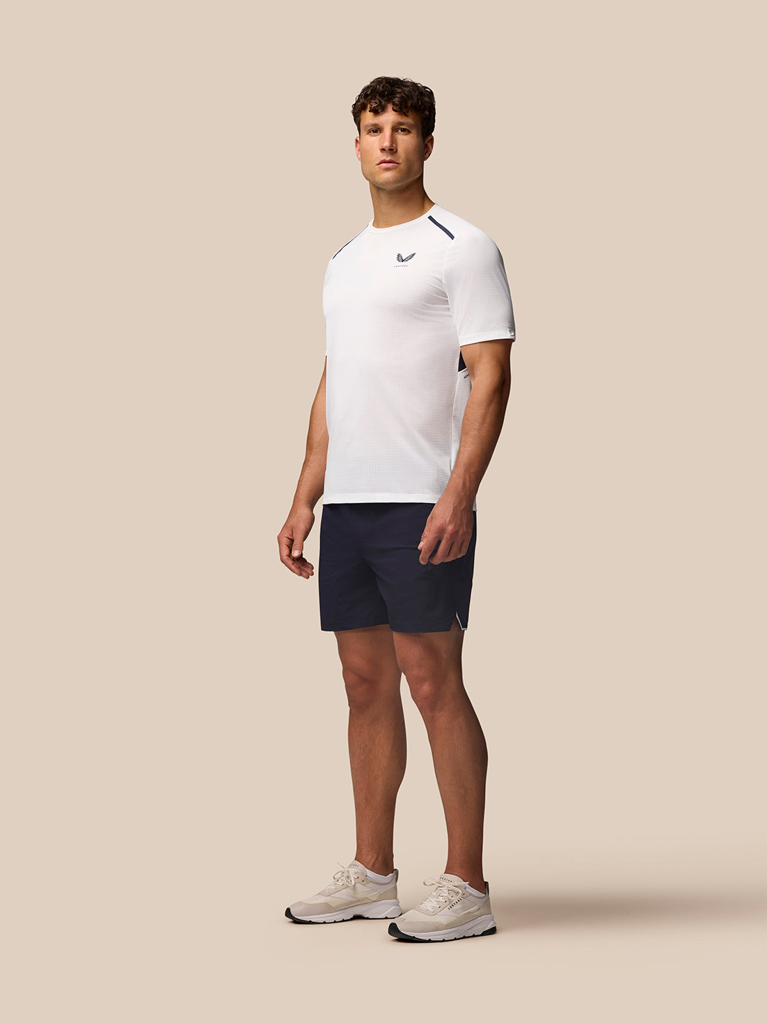 Side view of white Apex Training T-Shirt with navy panels and athletic fit