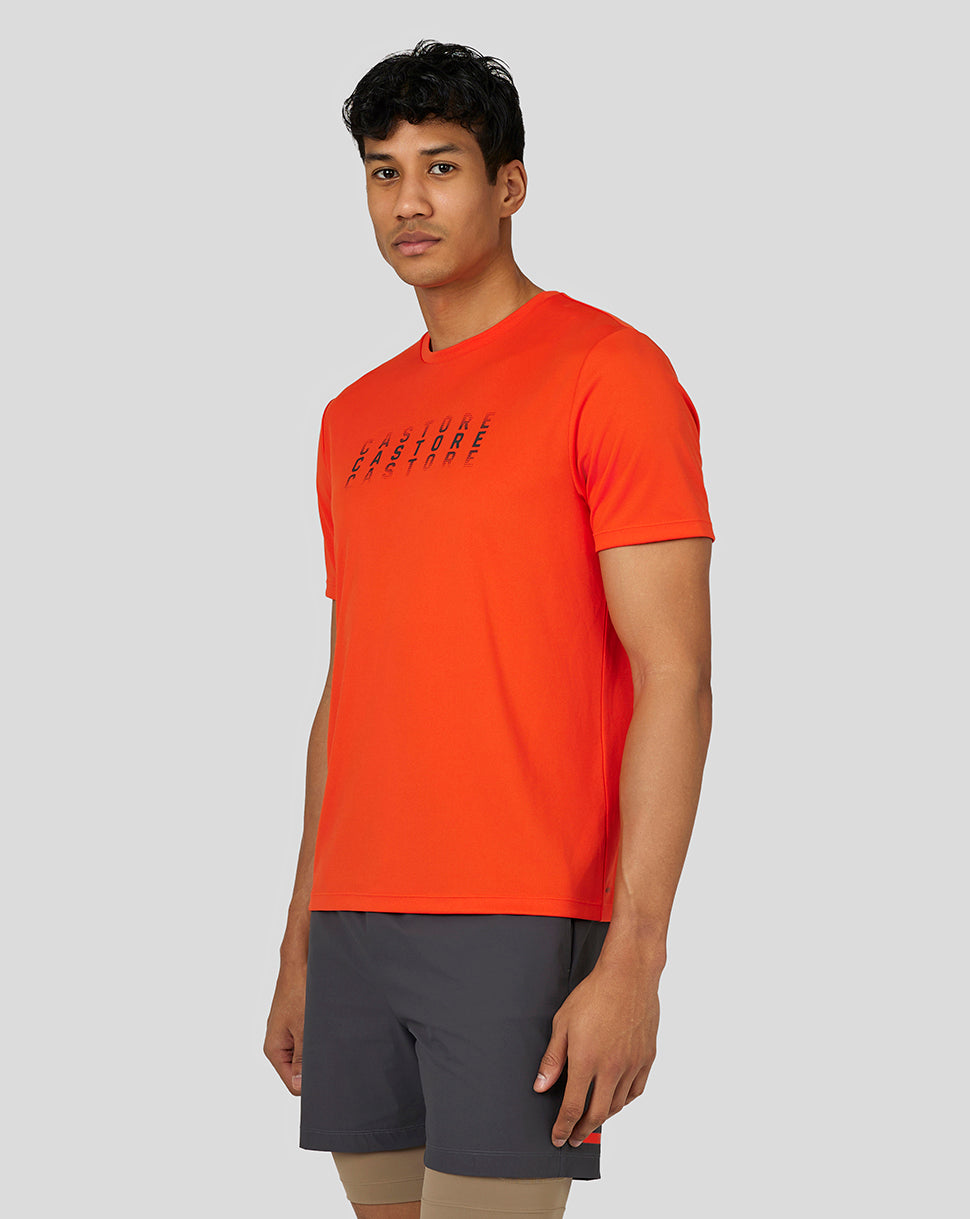 Male model wearing bright orange Flow Short Sleeve Graphic T Shirt with chest graphic