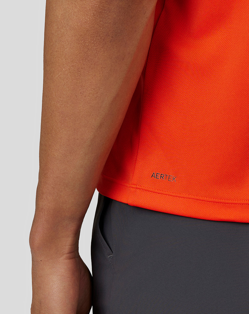 Close up of lower back hem showing AERTEK branding on the Deep Orange Flow Short Sleeve Graphic T Shirt.