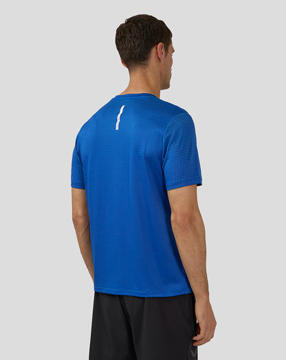 Back view of royal blue Flow Short Sleeve Knit T-Shirt with a white vertical logo detail on the upper back.