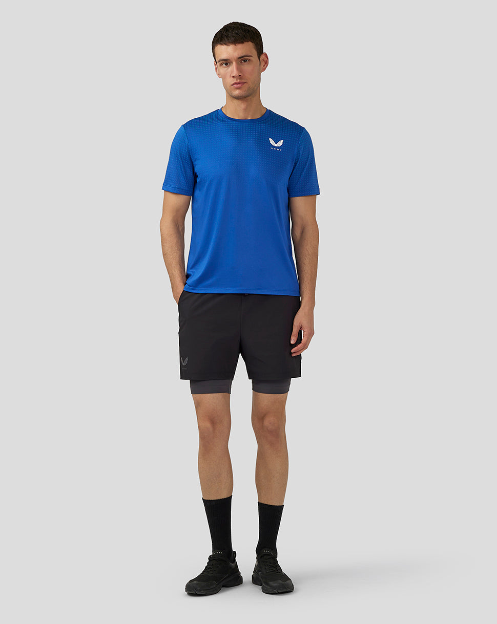 Man wearing royal blue Men’s Flow Short Sleeve Knit T Shirt with logo on chest front view