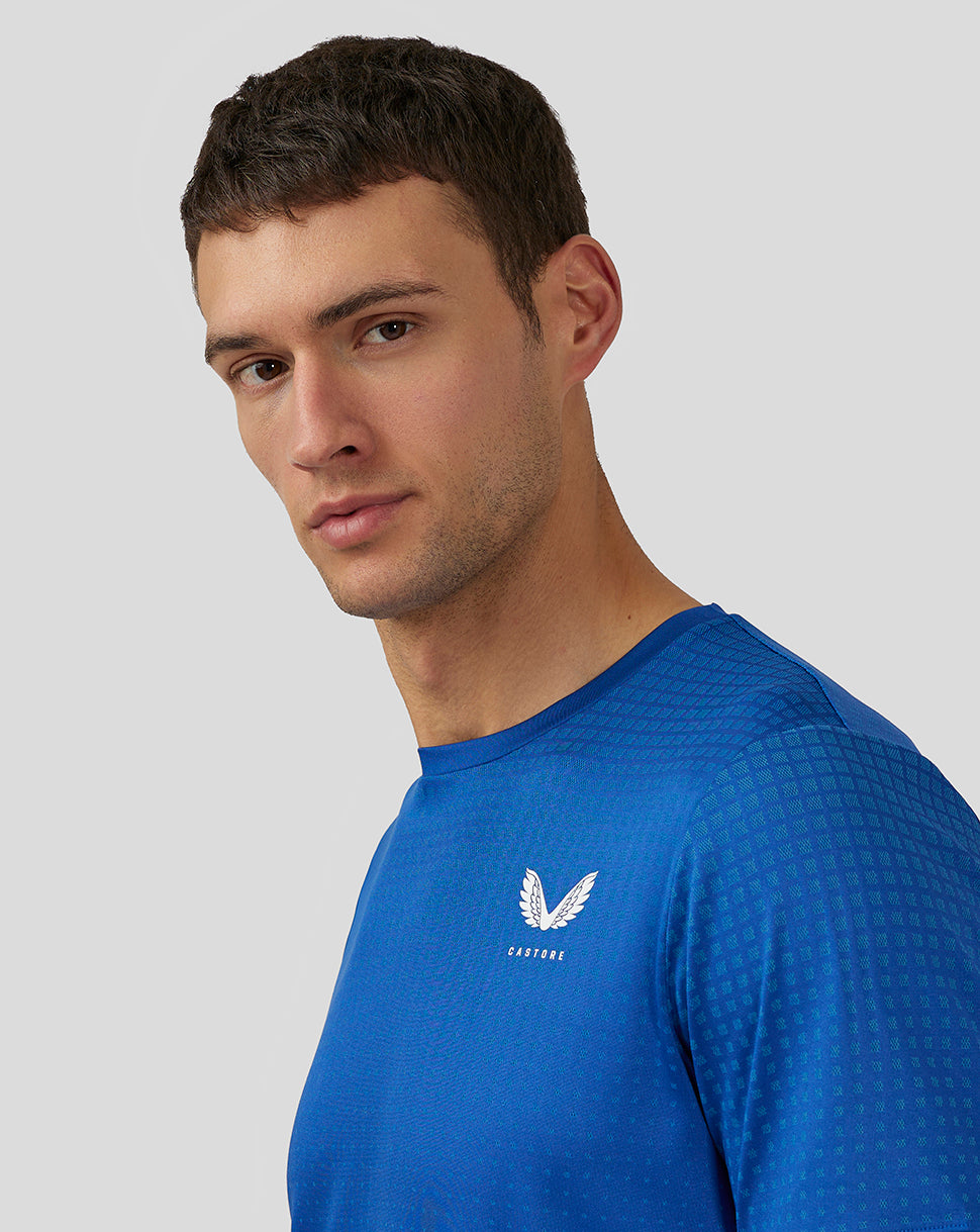 Close up of royal blue knit T Shirt showing logo on left chest and textured pattern