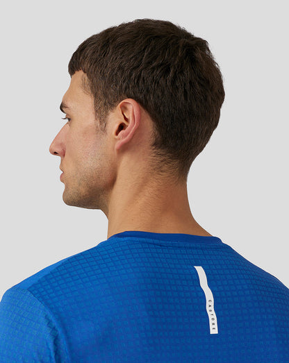 Back view of royal blue knit T Shirt with vertical white Castore branding down the back