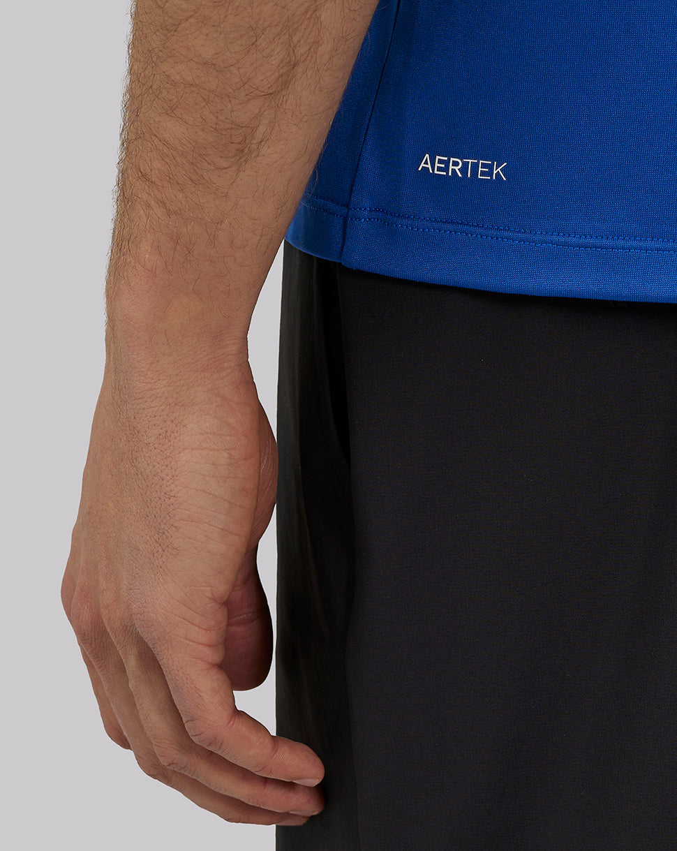 Close up of royal blue engineered knit training T shirt with AERTEK branding at hem.