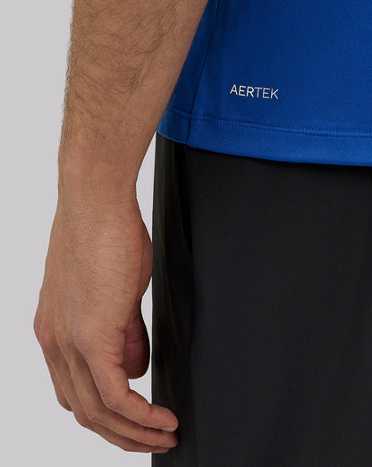 Close up of royal blue engineered knit training T shirt with AERTEK branding at hem.