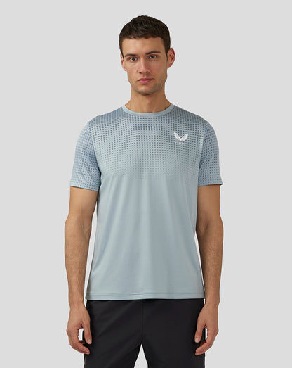 Front view of stone blue training T shirt with dotted upper chest pattern and Castore logo on chest.