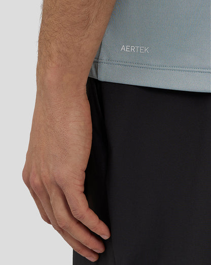 Back view of a man in a stone blue engineered knit T shirt with Aertek branding stripe along the back