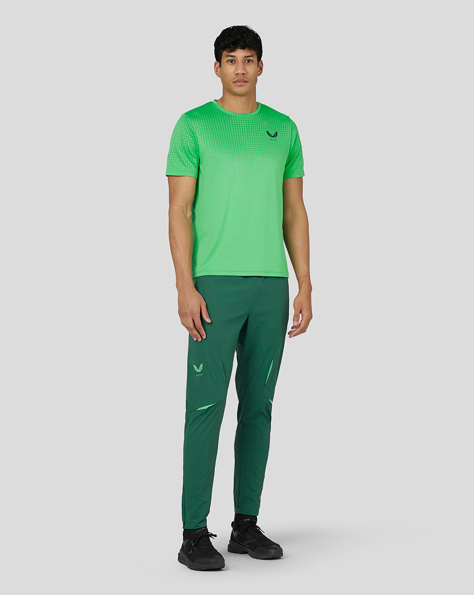 Angled front view of lime green Men’s Flow Short Sleeve Knit T-Shirt with gradient jacquard and Castore logo on chest