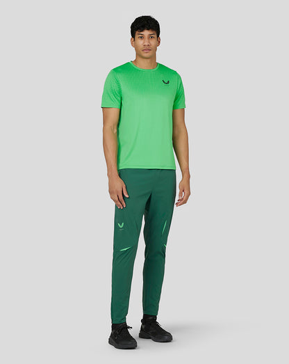 Angled front view of lime green Men’s Flow Short Sleeve Knit T-Shirt with gradient jacquard and Castore logo on chest
