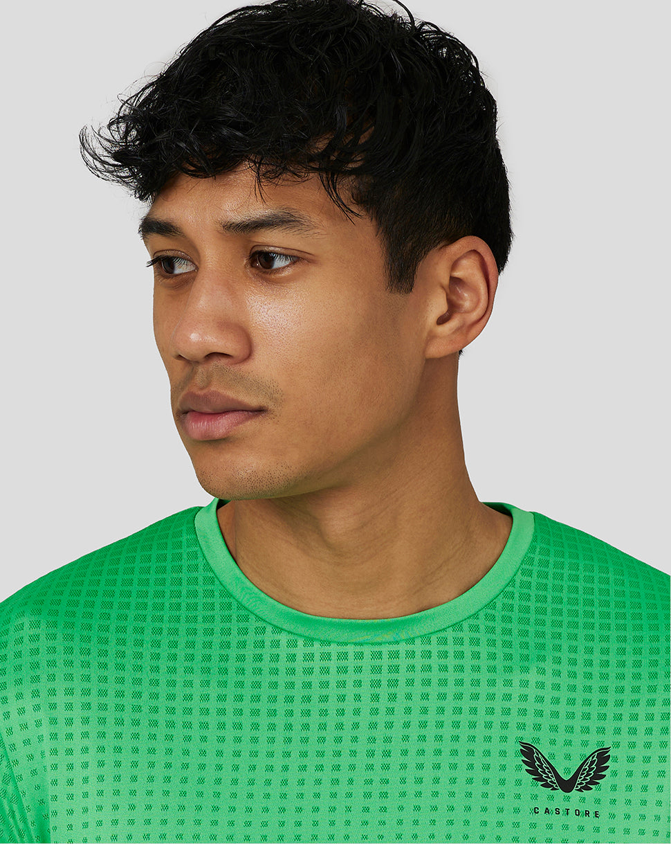 Male model wearing lime gradient jacquard knit T-shirt with Castore logo on the chest