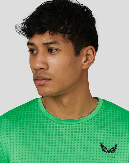 Male model wearing lime gradient jacquard knit T-shirt with Castore logo on the chest