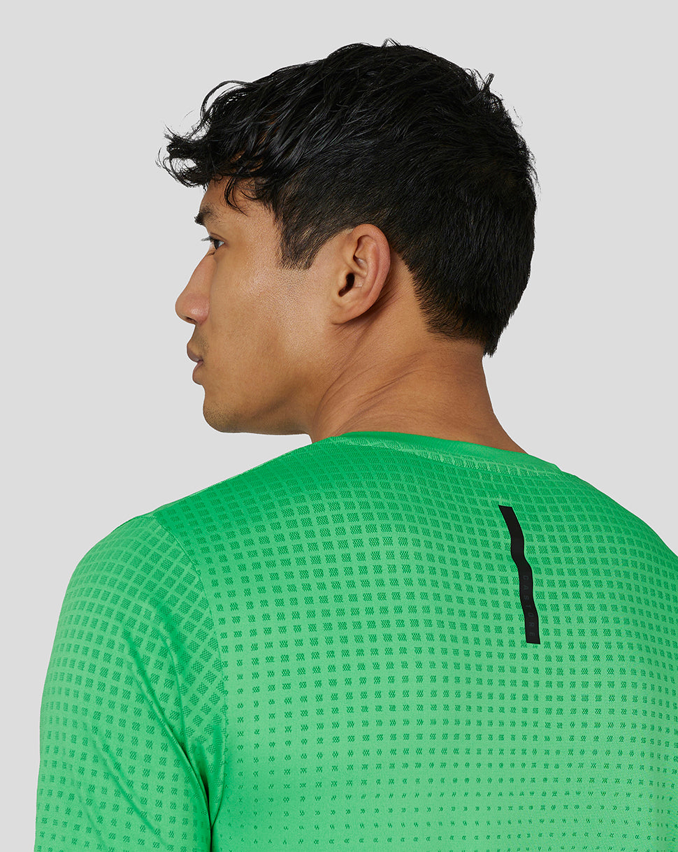 Profile view of male model wearing lime gradient jacquard knit T-shirt with back seam detail