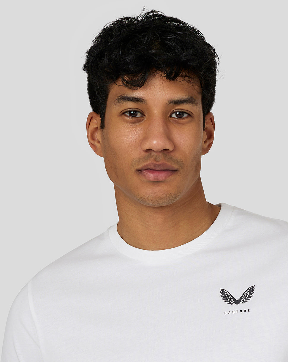 Close-up of a man wearing a white Castore Men’s Flex Short Sleeve T Shirt with a small left chest logo