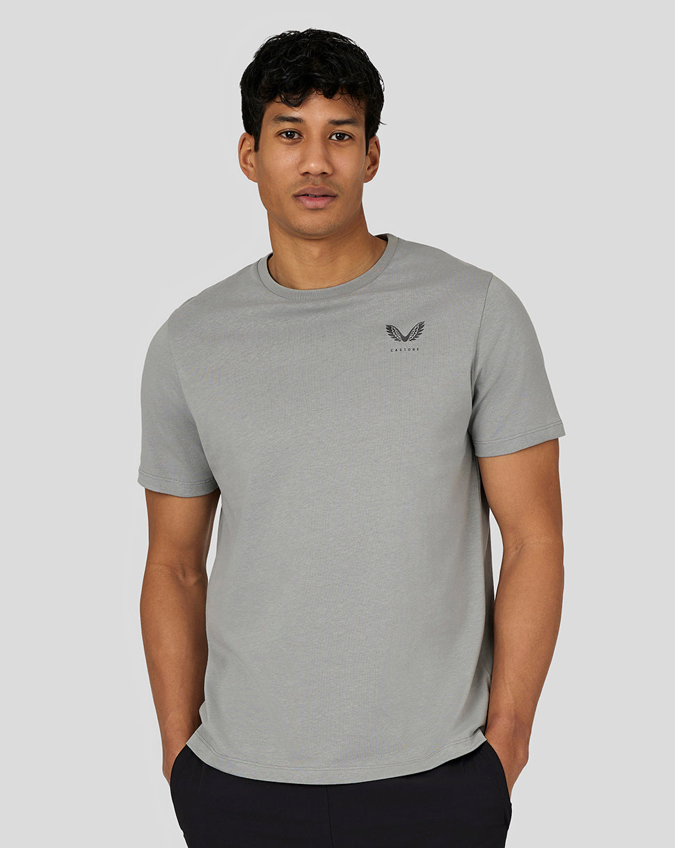 Male model wearing steel Men’s Flex Short Sleeve T Shirt with crew neck and small left chest Castore logo