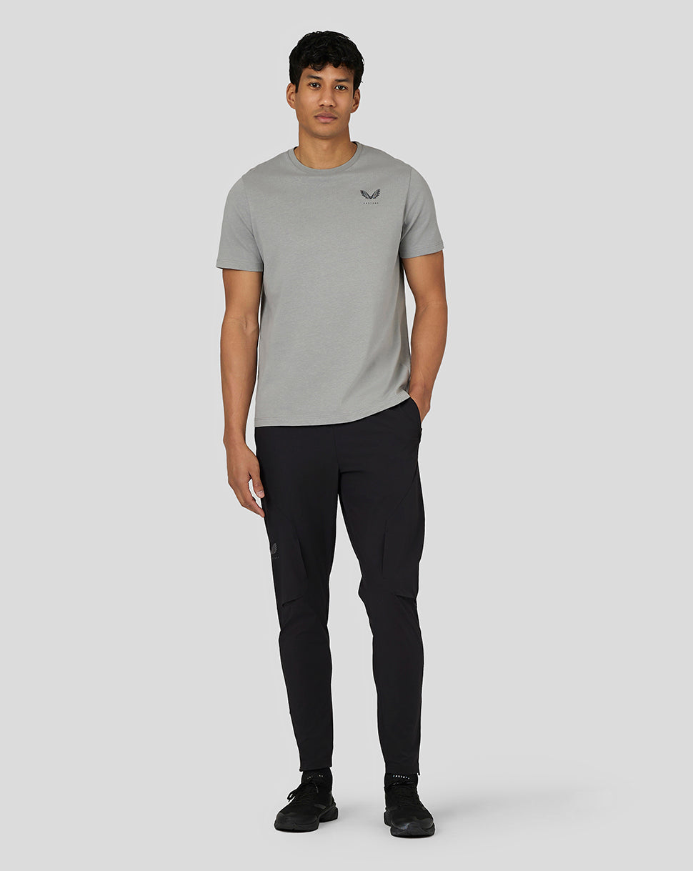Male model in steel grey Castore Men’s Flex Short Sleeve T Shirt paired with black cargo pants