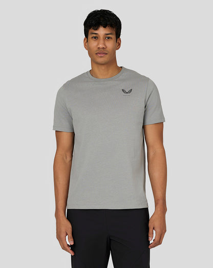 Full body shot of a male model in steel grey Castore Men’s Flex Short Sleeve T Shirt with black pants
