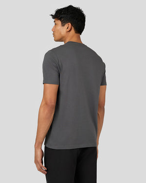 Back view of a male model wearing the gunmetal gray Castore Flex Short Sleeve T Shirt