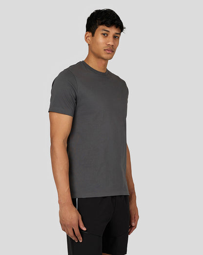 Side view of a man wearing a gunmetal Men’s Flex Short Sleeve T-Shirt with a left chest logo.
