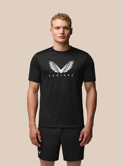 Front view of a man in a black Adapt Graphic Training T-Shirt with a white wing graphic on the chest