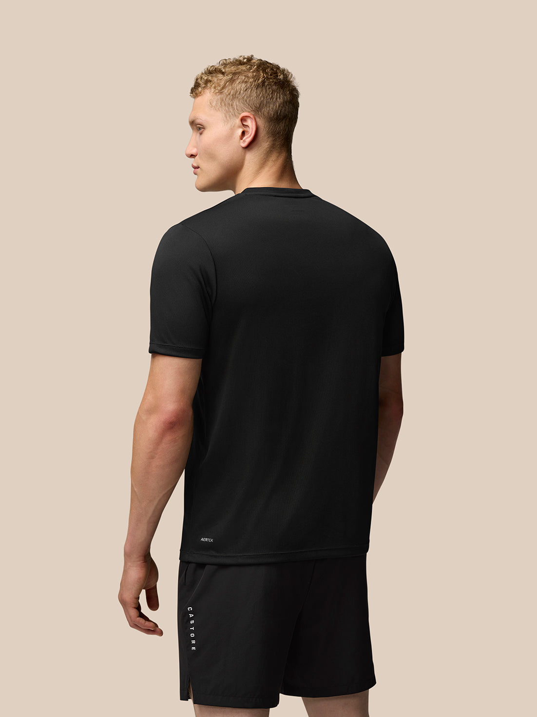 Back view of black Adapt Short Sleeve Graphic T-Shirt with Aertek branding at the lower back