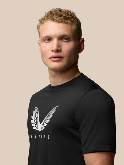 Male model wearing black Adapt Short Sleeve Graphic T Shirt with white wings logo on the chest.