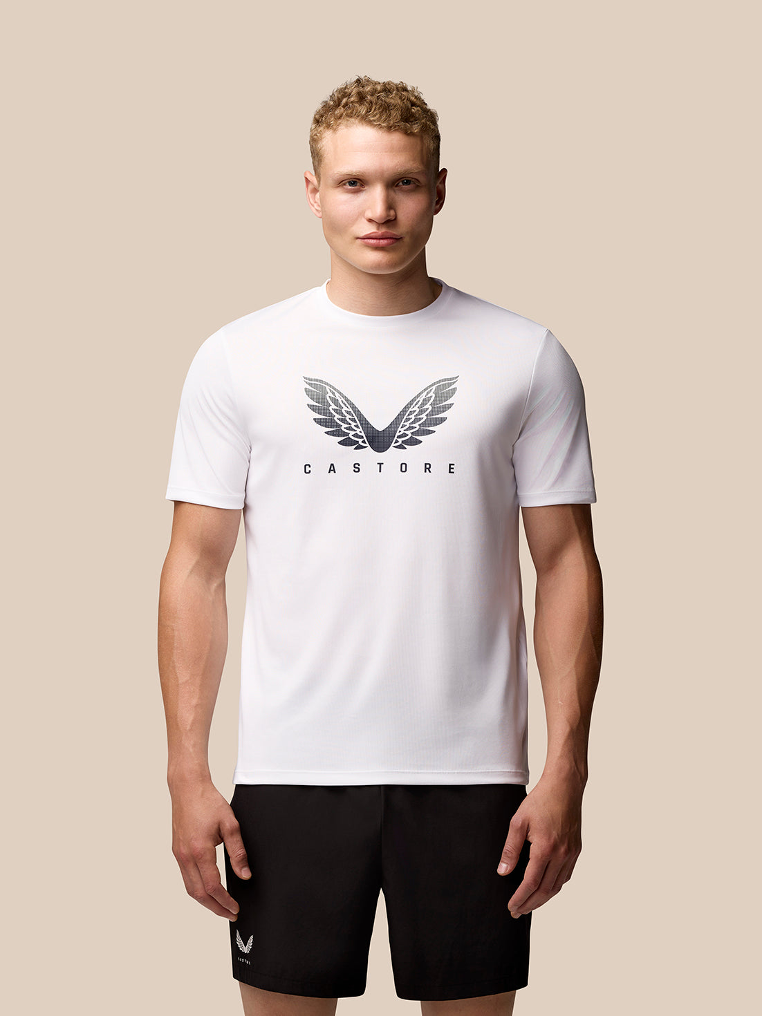 Front view of a man wearing white Adapt Graphic Training T-Shirt with Castore wings logo on the chest