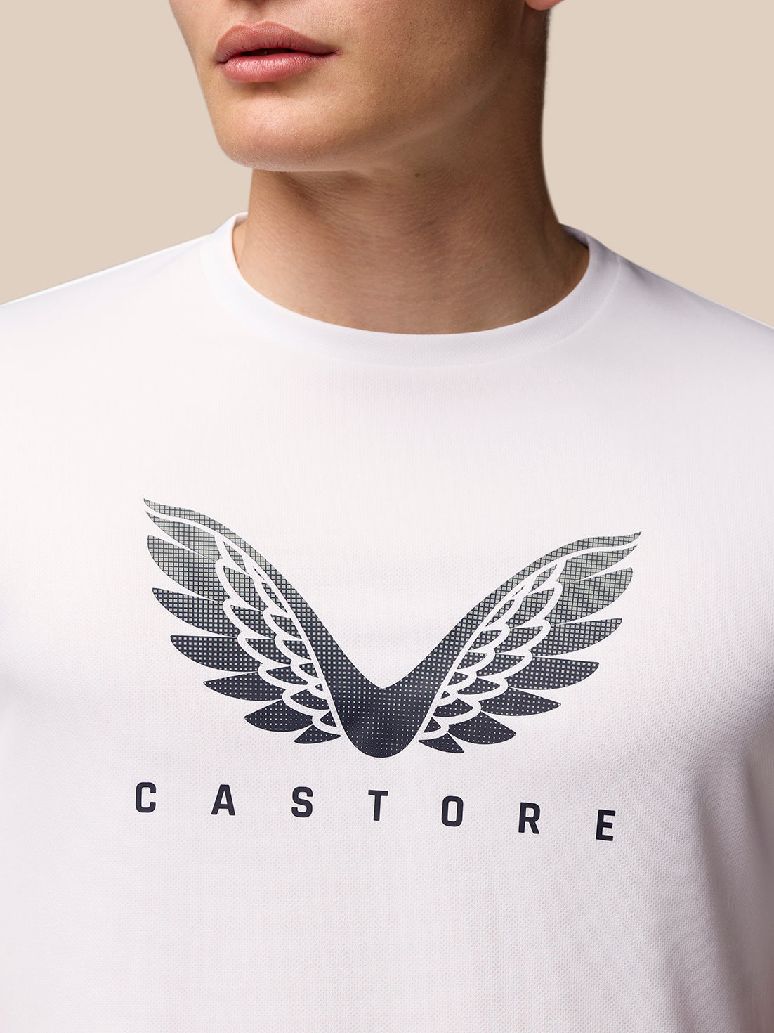 Back view of a man wearing white Adapt Graphic Training T-Shirt with small branding at the lower back hem