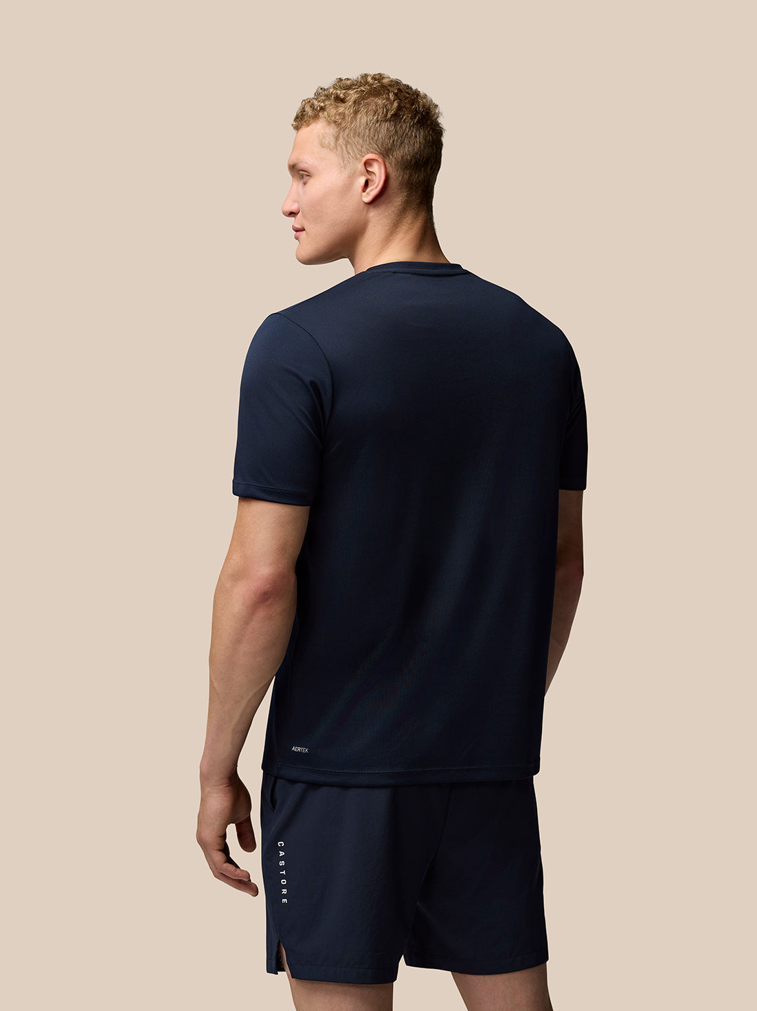 Back view of midnight navy Adapt Training T-Shirt with Aertek branding at the lower back