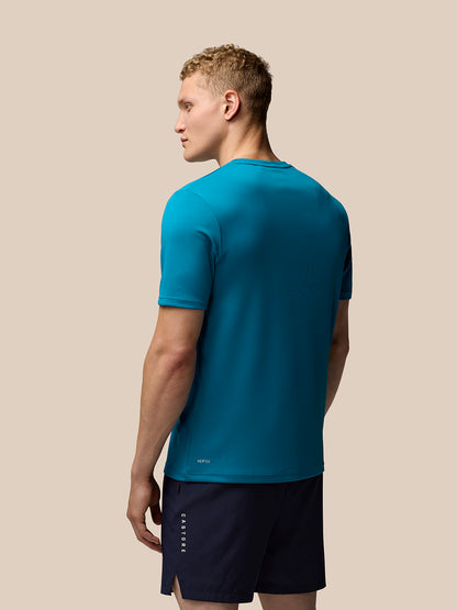 Back view of teal Adapt Short Sleeve Graphic T Shirt with small Aertek branding at the lower back.