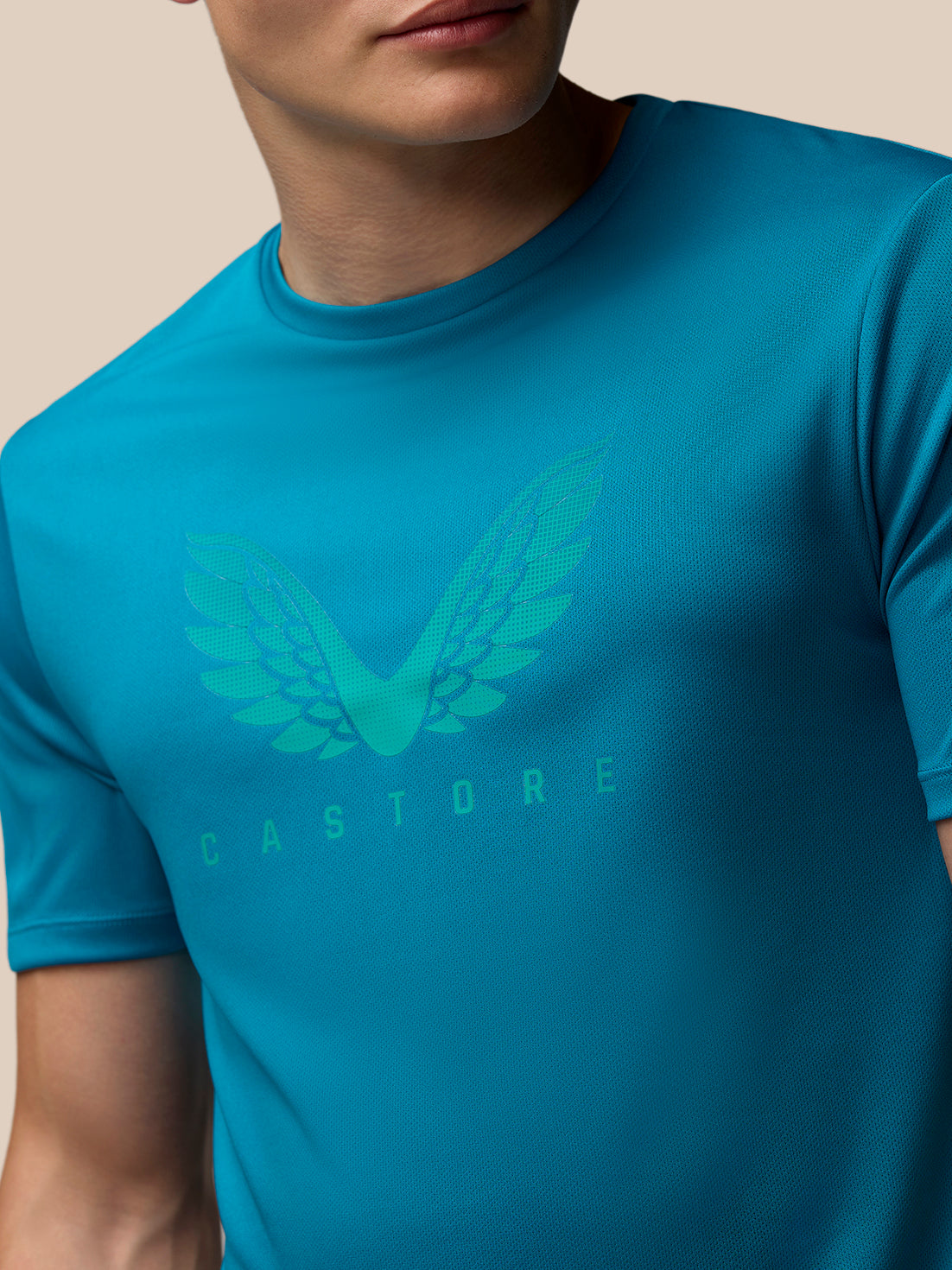 Close-up of turquoise Adapt Training T-Shirt with a wing logo on the chest